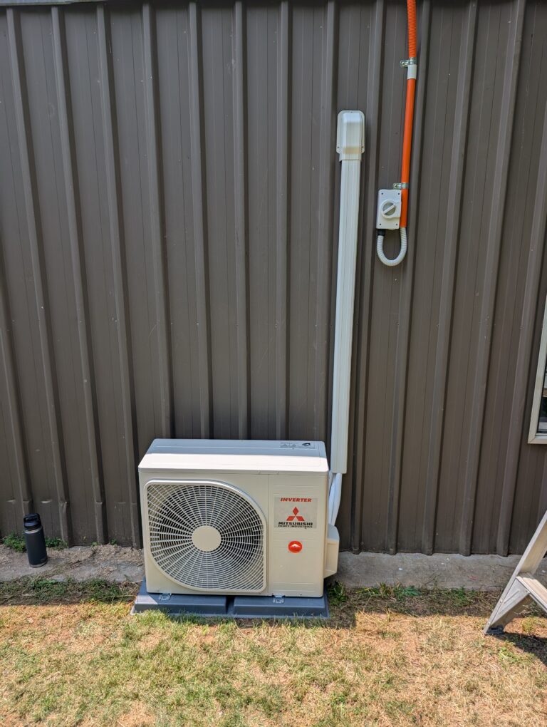 Mitsubishi Heavy Industries split system air conditioner installed on exterior wall with neatly run conduit
