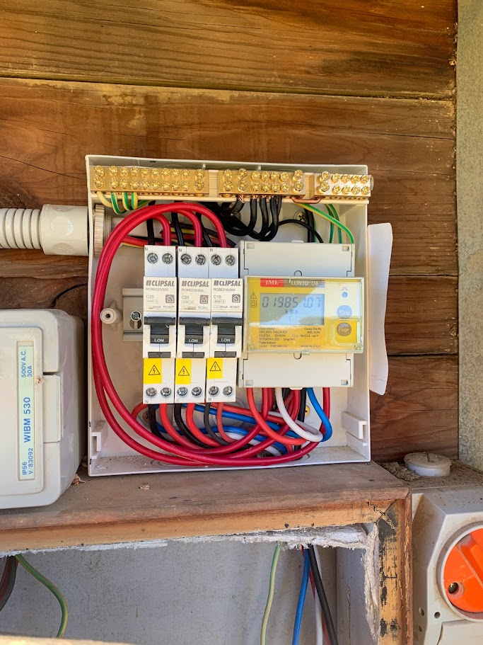 Switchboard with Clipsal breakers and digital power consumption meter in timber framing